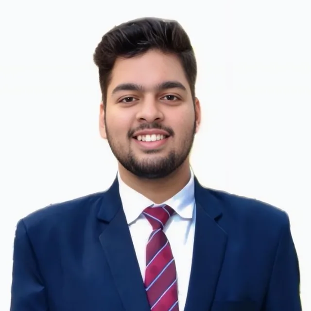 Garv Gupta in a navy suit and striped tie